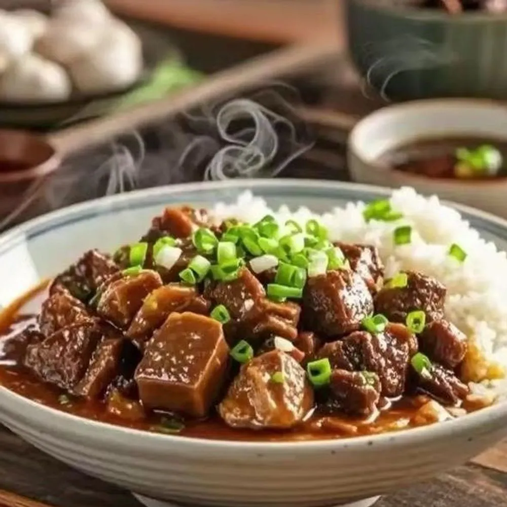 Braised beef brisket cubes over steamed rice with savory brown sauce and green onions at Noodles + BBQ, a Chinese Restaurant in Los Angeles