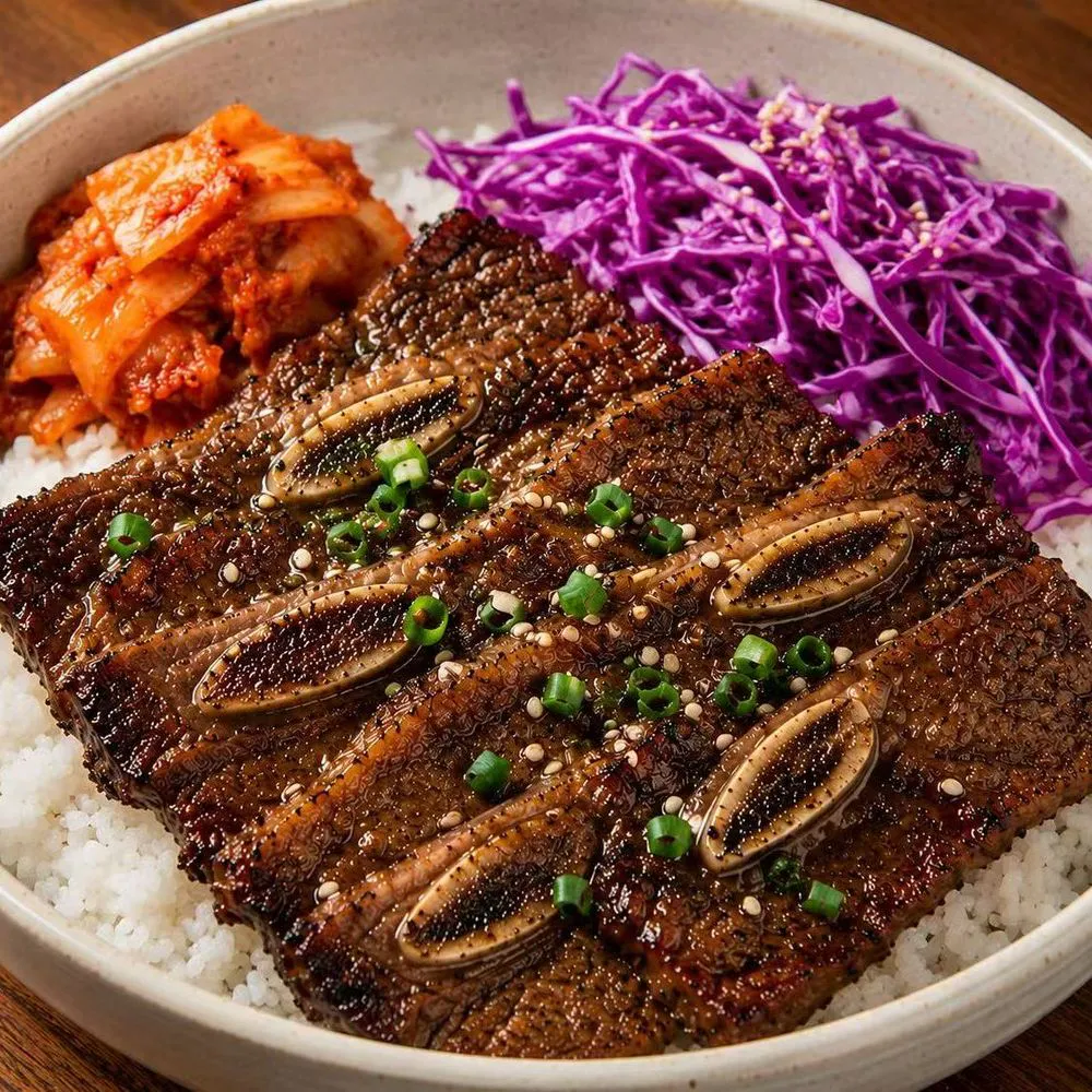 Grilled beef short rib rice bowl with kimchi and shredded purple cabbage at Noodles + BBQ, a Chinese Restaurant in Los Angeles
