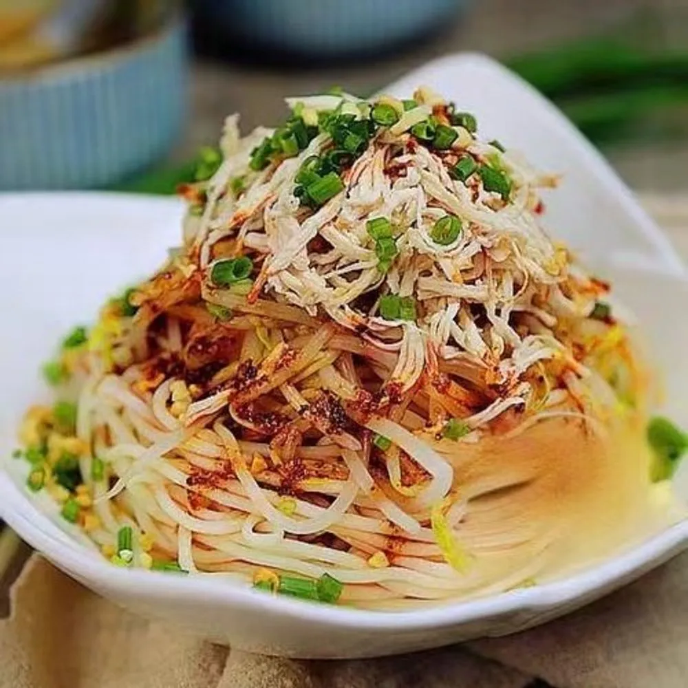 Cold shredded chicken noodle salad tossed with chili oil and chopped green onions at Noodles + BBQ, a Chinese Restaurant in Los Angeles